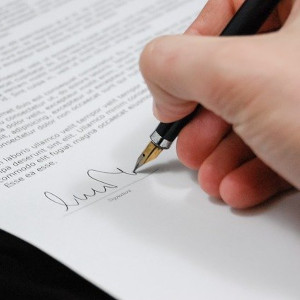 Hand signing a document